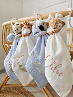 three personalized towels hanging from a rack with teddy bears on them and the word hello