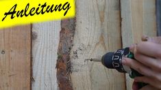 a person using an electric drill to attach wood planks with text overlaying