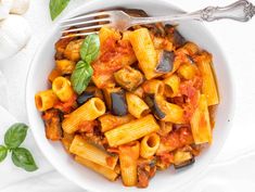 a white bowl filled with pasta and vegetables