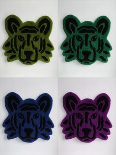 four different colored tiger patches with black, green, purple and blue designs on them