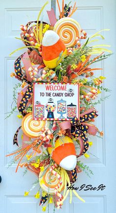 a welcome to the candy shop door hanger with lollipops and candies