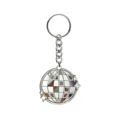 a metal keychain with a globe on it's side and an arrow in the middle