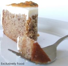 a piece of cake sitting on top of a white plate with a fork next to it