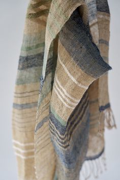 a tan and blue plaid blanket hanging from a hook