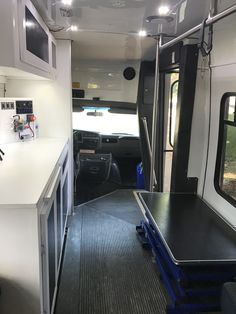 the inside of a camper that is equipped with kitchen and dining area, including an island