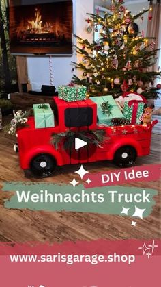 a red truck with presents on the bed in front of a christmas tree and fireplace