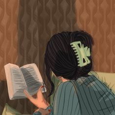 a woman sitting on a couch reading a book