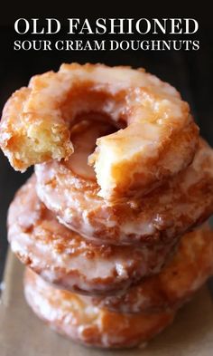 three glazed donuts stacked on top of each other with the words old fashioned sour cream doughnuts