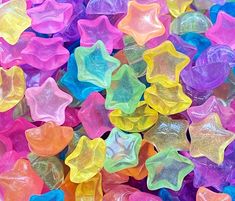 many different colored star shaped candies in a pile