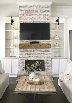 a living room filled with furniture and a flat screen tv mounted on the wall above a fireplace