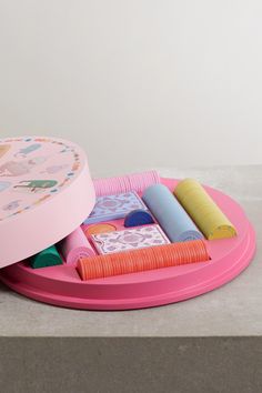 a pink tray with different colored objects on it