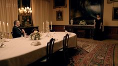 a man and woman sitting at a dinner table