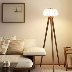 a living room scene with focus on the floor lamp and white couch in the foreground