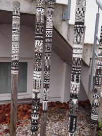 there are many decorative poles in front of the house