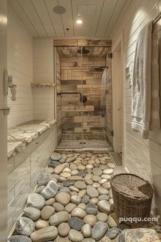 a bathroom with rocks on the floor and walls