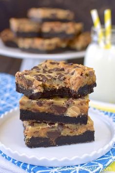 three pieces of chocolate chip cookie bars stacked on top of each other with milk in the background