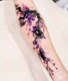 the arm is covered with purple flowers and black ink