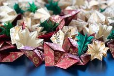 several origami flowers sitting on top of a blue table