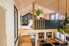 the interior of a tiny house with stairs leading up to an upper level loft bed