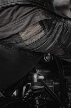 the back end of a motorcycle with some black leather on it's side pocket