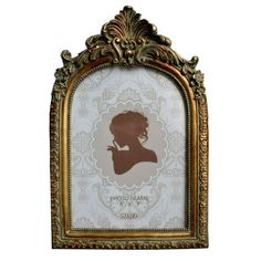 an ornate gold frame with a silhouette of a woman on the front and side, against a white background