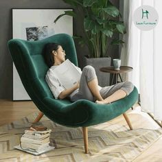 a woman sitting in a green chair with her head resting on the armrests