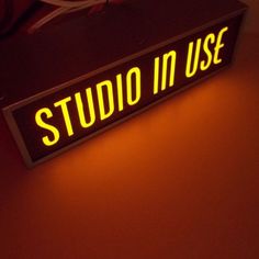 a neon sign that says studio in use