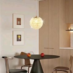 a table with two chairs and an apple on it