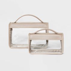 two clear purses sitting side by side on top of each other in front of a white background