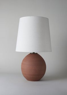 a brown table lamp with a white shade on it