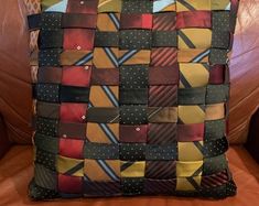 a decorative pillow made out of ties on a couch