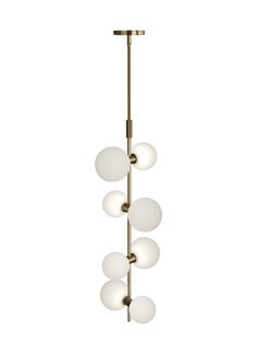 a brass chandelier with five white glass balls hanging from the bottom and four gold metal poles