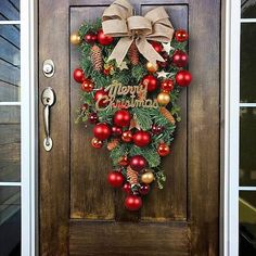 a christmas wreath hanging on the front door