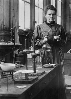 an old black and white photo of a woman in a lab