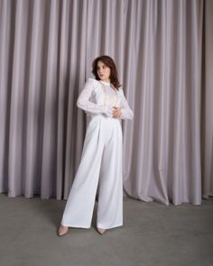 Be the center of attention in this white jumpsuit designed to make you the center of attention. Don't miss the opportunity to flaunt this incredibly elegant piece that is as versatile as it is chic. This white long sleeve wedding jumpsuit is an indispensable fashion item for any woman who seeks style, comfort and sophistication. The fitted cut accentuates your curves, while the white wedding jumpsuit offers a refreshing alternative to traditional gowns. Thanks to the exquisite Italian lace, it c Elegant Long Sleeve Lace Jumpsuits And Rompers, Lace Long Sleeve Jumpsuits And Rompers For Party, Fitted Long Sleeve Jumpsuits And Rompers For Wedding, Elegant Jumpsuit With Sheer Long Sleeves, Chic Long Sleeve Jumpsuit For Wedding, Lace Jumpsuits And Rompers For Wedding, Chic Long Sleeve Jumpsuits And Rompers For Wedding, White Long Sleeve Jumpsuits For Evening, White Long Sleeve Jumpsuits And Rompers For Evening