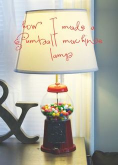 a lamp that is on top of a table next to a sign reading how t made a gumball machine lamp?