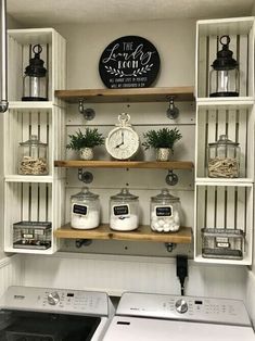 a washer and dryer in a small room with shelves above the washer