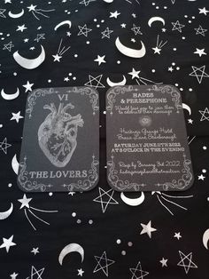 two coasters sitting on top of a table covered in stars and moon designs