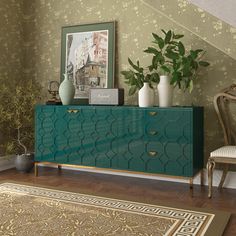 a green cabinet with gold accents in a room next to a stair case and chair