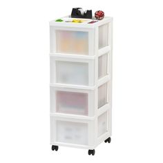 a white plastic storage unit with four bins on wheels and three different colored drawers