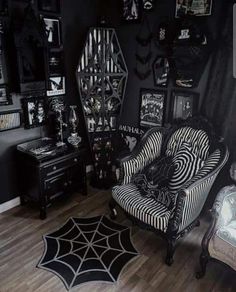 a black and white living room with spider web rugs on the hardwood flooring