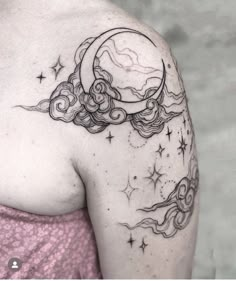 a woman's shoulder with a crescent and stars tattoo on her left arm, the moon