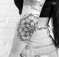 a woman's arm with a flower tattoo on the left side of her body