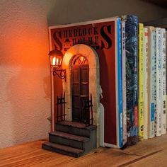 the books are lined up on the shelf next to the lamp and bookends