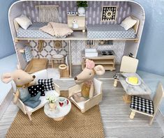 a doll house with two mice sitting in chairs