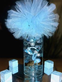 a vase filled with blue flowers and ice cubes