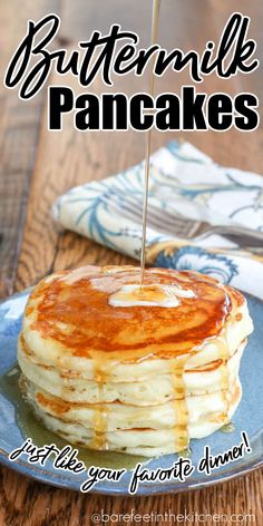 a stack of pancakes on a plate with syrup being drizzled over them