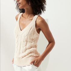 Sustainable: Made With Certified Organically Grown Cotton. V/Neck, Straight Hem, Semi-Fitted. Color Is Off-White Beige Cable Knit V-neck Top, Beige V-neck Cable Knit Top, Cream Cotton V-neck Knit Top, Stretch Cable Knit V-neck Top, Spring Cable Knit V-neck Tops, Chic Cable Knit V-neck Top, Fitted V-neck Cable Knit Top, Beige V-neck Cotton Knit Top, Organic Cotton Yarn