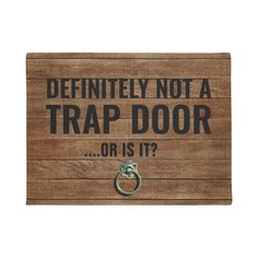 a wooden sign that says, definitely not a trap door or is it?