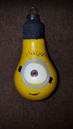 a yellow light bulb shaped like a minion with an eye on it's side